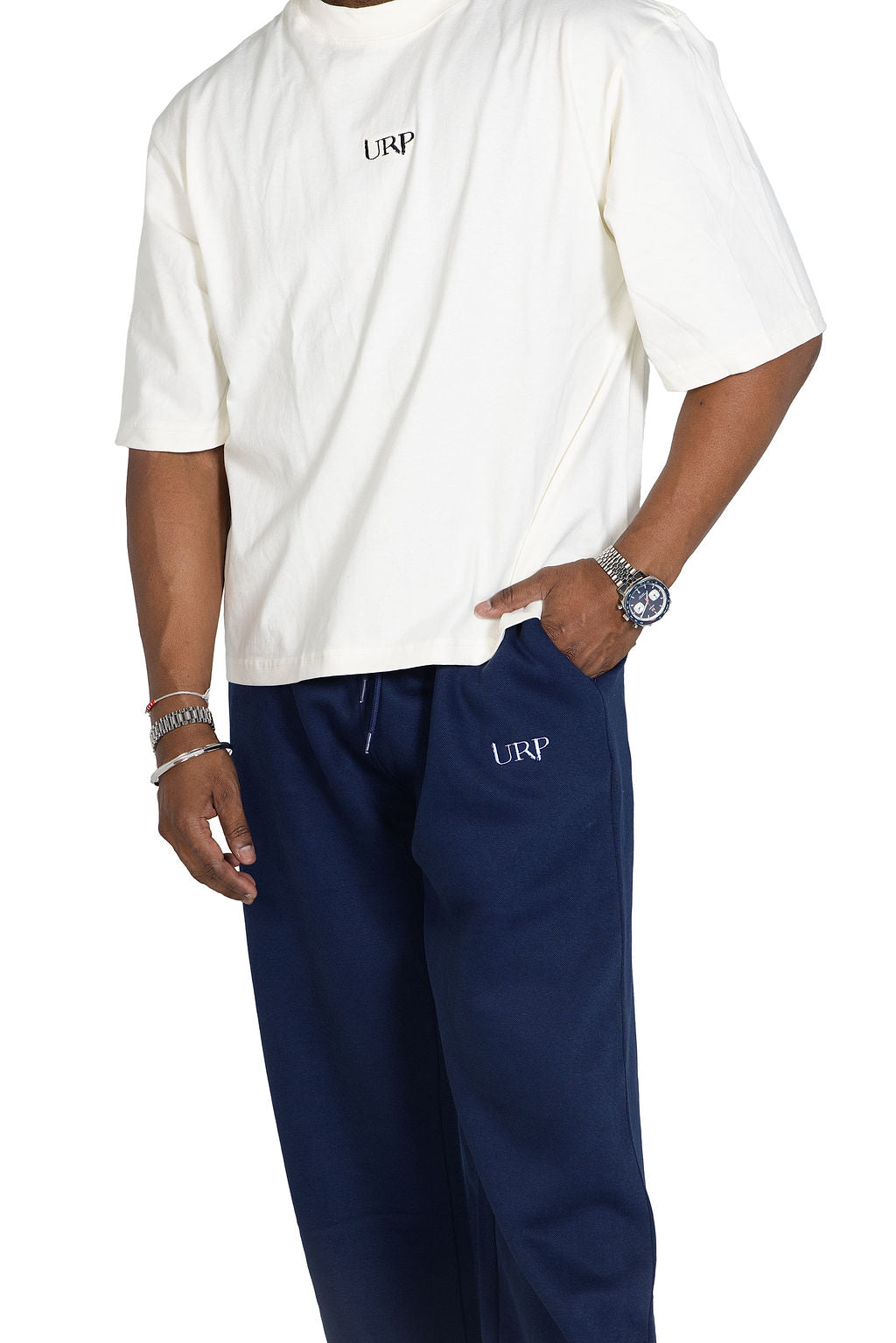 Close view of the drawcord, pocket and URP logo on blue wide-leg joggers.